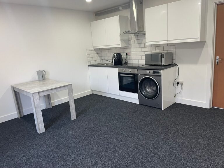 HMO communal kitchen after clean — white units, hob and appliances wiped, Birmingham.