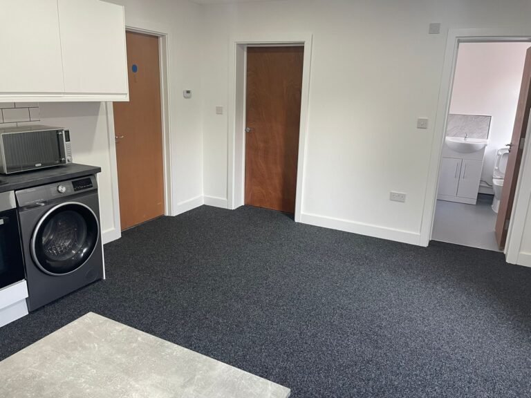 HMO communal area after clean — floors vacuumed, doors and skirtings detailed.