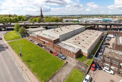 Exterior of a modern industrial unit in the Aston Advanced Manufacturing Hub, representative of engineering and automotive facilities in Birmingham.